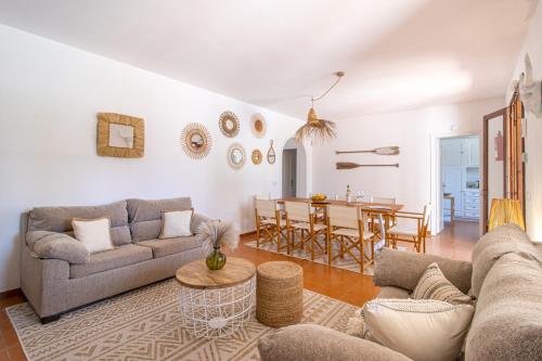 a living room with a couch and a table at Villa Linda by 3VILLAS in Son Parc