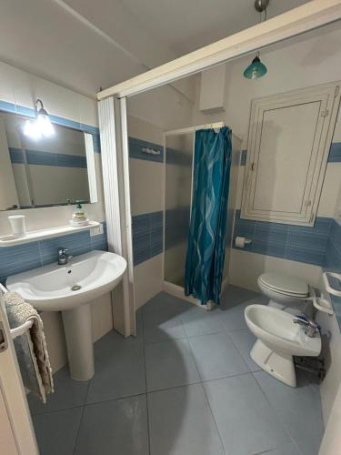 a bathroom with a sink and a toilet and a shower at Capo Scalambri in Santa Croce Camerina