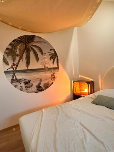 a bedroom with a bed and a painting on the wall at Logement Pirate themed suite with parking in Vesoul