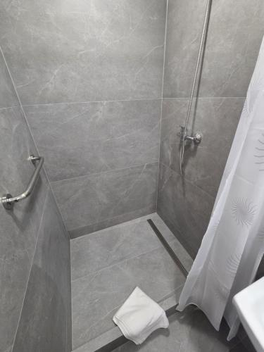 a bathroom with a shower with a shower curtain at Hotel Incognito in Jáchymov