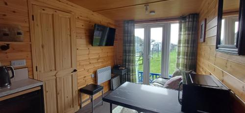 a small room with a table and a window at Mardi Gras, Upwell in Upwell
