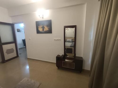 a room with a mirror on the wall next to a door at 1 bhk apartment ruby residency in Canacona