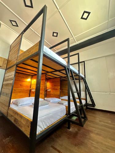 a bedroom with two bunk beds in a room at Yellow Umbrella Hostels in Cebu City