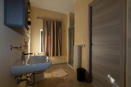 a bathroom with a white sink and a shower at La reggia di Gianfry in Fermo