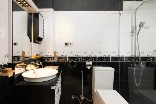 a black and white bathroom with a sink and a toilet at Oak Ray Misty Hills in Nuwara Eliya