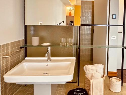 a bathroom with a sink and a glass wall at Hotel SunClub CalaVinya in Salou