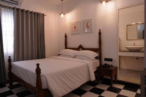 a bedroom with a large bed and a sink at The Polaris in Cochin