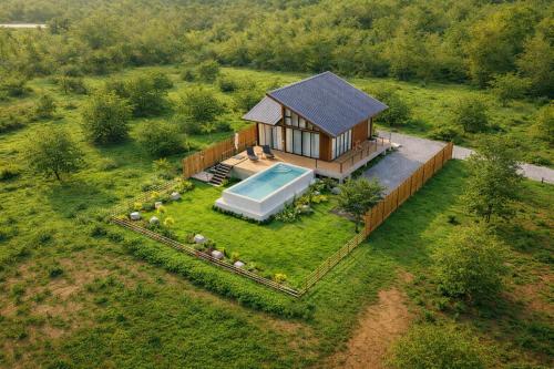 an overhead view of a house with a swimming pool at Solitude Villas in Ban Chang Talut