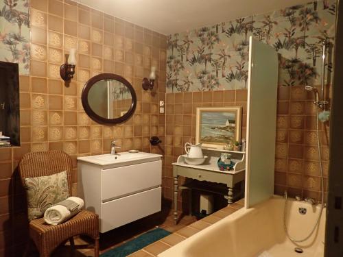 a bathroom with a sink and a mirror and a tub at Bramfam in Gresse-en-Vercors