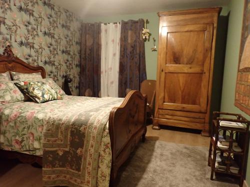 a bedroom with a bed and a wooden door at Bramfam in Gresse-en-Vercors
