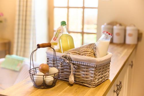 a basket of groceries sitting on a kitchen counter at Gooseyard at Middle Farm and Cottages in Picklescott