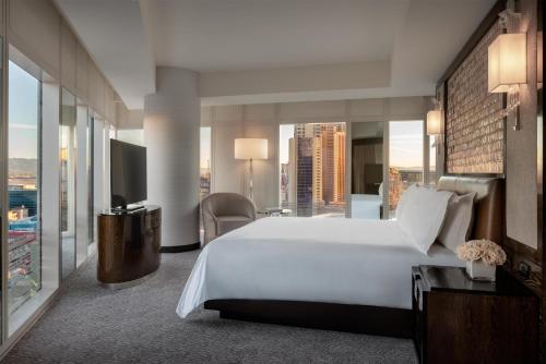 a hotel room with a bed and a view of a city at Waldorf Astoria Las Vegas in Las Vegas