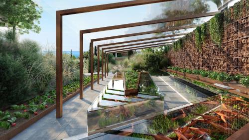 a garden with aquatic plants and a brick wall at Higuerón Hotel Málaga, Curio Collection by Hilton in Fuengirola