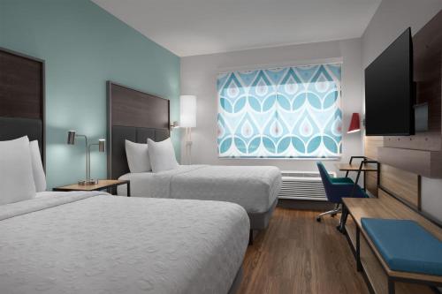 a hotel room with two beds and a window at Tru By Hilton Huntsville Research Park Area in Huntsville
