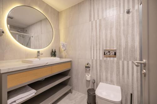 a bathroom with a sink and a mirror at La Quinta by Wyndham Bodrum in Bodrum City