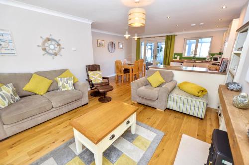 a living room with a couch and a table at 18 Marriotts Way in Sheringham