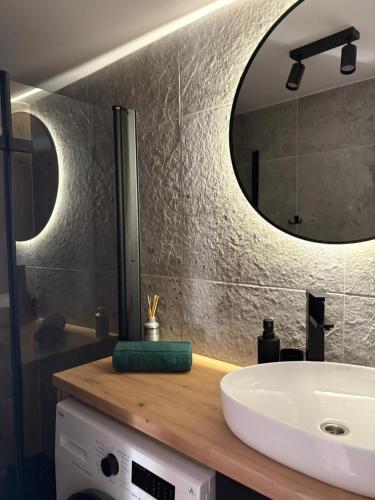 a bathroom with a sink and a mirror at Przystanek Stodoła in Rajcza