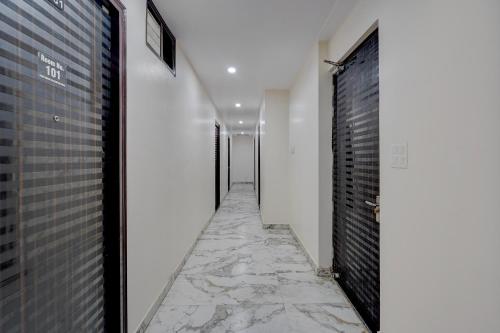 a corridor with white walls and a stone walkway at FabHotel Metro Inn in Kānpur