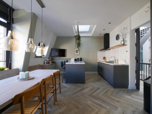 a kitchen and dining room with a table and chairs at Hosted by Wendy Prins Willem 3 in Scheveningen