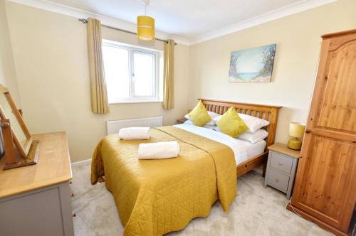 a bedroom with two beds and a window at 18 Marriotts Way in Sheringham