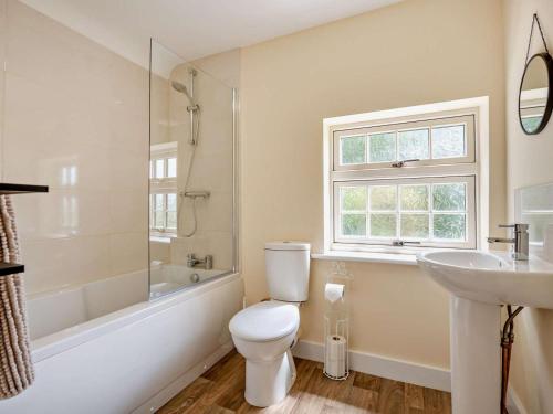 a white bathroom with a toilet and a sink at 2 Bed in Alford oc-92252 in Rigsby