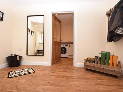 a room with a mirror and a wooden floor at 3 Bed in Alford oc-55963 in Rigsby