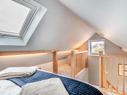 a attic bedroom with a bed and a staircase at 1 Bed in Gloucester oc-95793 in Tirley