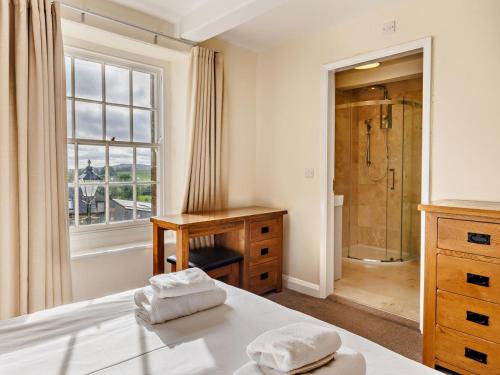 a bedroom with a shower and a bed with two towels at 6 Bed in Buxton oc-77369 in Longnor