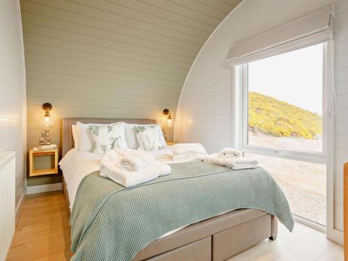 a bedroom with a bed with towels on it at 2 Bed in Tain oc-81339 in Nigg
