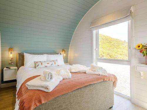 a bedroom with a bed with towels on it at 1 Bed in Tain oc-81337 in Nigg