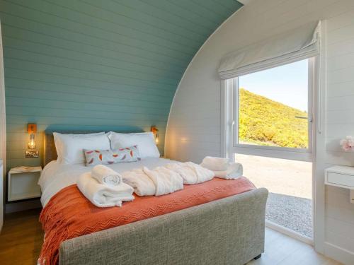 a bedroom with a bed with towels on it at 1 Bed in Tain oc-81338 in Nigg