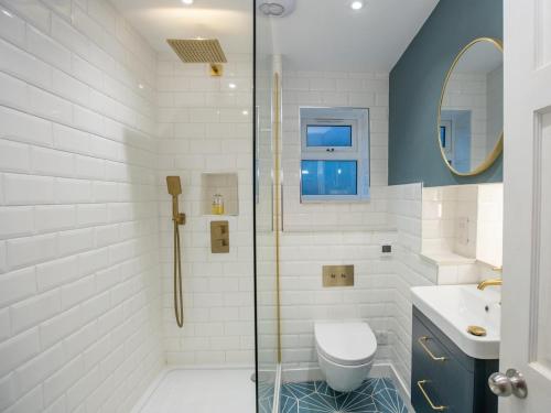 a bathroom with a shower and a toilet and a sink at 3 Bed in Kings Lynn oc-43950 in Docking