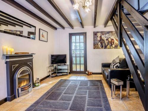 a living room with a couch and a fireplace at 2 Bed in Llandysul oc-79199 in Felindre