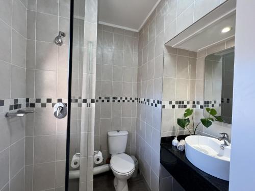 a bathroom with a toilet and a sink at Ocean Daze Brookes Hill Suites - Beachfront Flat in Summerstrand