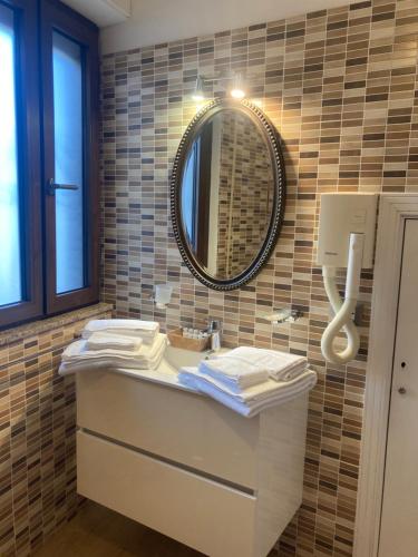 a bathroom with a sink and a mirror at Elegant mini appartments Floridia close to the center private parking in Taormina