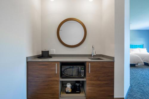 a bathroom with a sink and a mirror at Hampton Inn & Suites Edmonton St. Albert, Ab in Edmonton