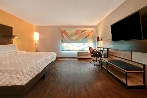 a hotel room with a bed and a flat screen tv at Tru By Hilton Albuquerque North I-25, Nm in Albuquerque