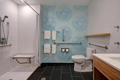 a bathroom with a toilet and a shower at Tru By Hilton Albuquerque North I-25, Nm in Albuquerque
