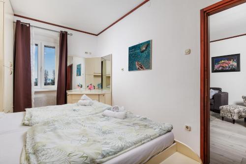 a bedroom with a large bed and a mirror at Apartment Audrey - free parking by Irundo in Rijeka
