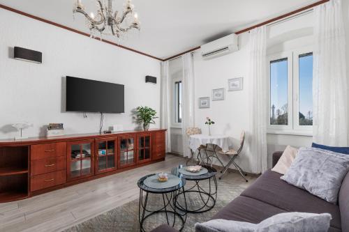 a living room with a couch and a tv at Apartment Audrey - free parking by Irundo in Rijeka