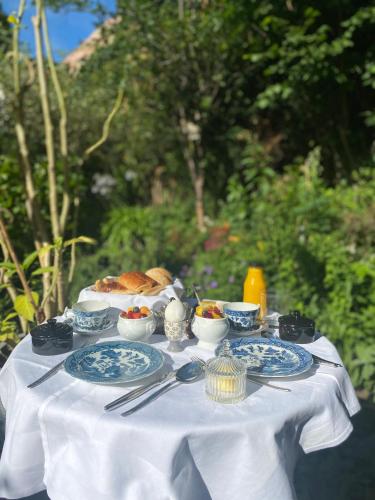 a white table with plates of food on it at B&B Royal Swans - Adults-Only Boutique Stay in Bruges in Bruges