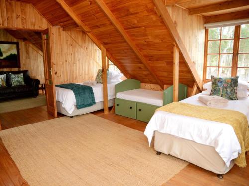 a room with two beds in a attic at Farside Macadamias in Riversdale