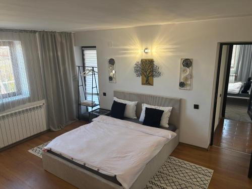 a bedroom with a large bed in a room at MIK Chalet in Săcele