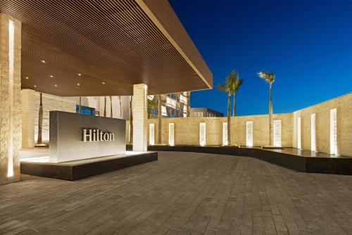 a building with a sign on the side of it at Hilton Cancun, an All-Inclusive Resort in Cancún