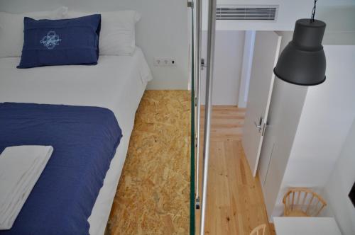 a bedroom with a bed and a glass wall at Casa de São Bento by PURUS in Coimbra