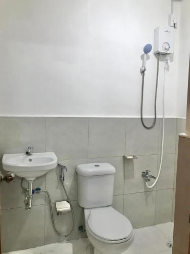 a bathroom with a toilet and a sink at ErrZ Homestay in Malaybalay in Malaybalay