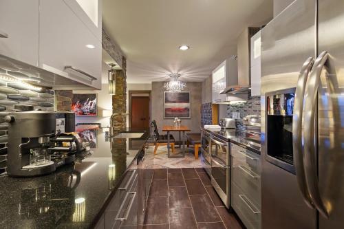 a kitchen with stainless steel appliances and a dining room at Holiday Inn Club Vacations at Desert Club Resort in Las Vegas