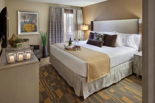 a bedroom with a large bed with a tray on it at Holiday Inn Club Vacations at Desert Club Resort in Las Vegas