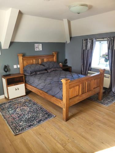 a bedroom with a wooden bed in a room at Three horse shoes in Durham