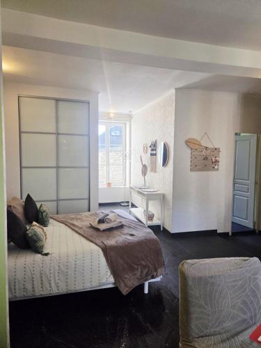 a bedroom with a large bed and a window at STUDIO DE L'HORLOGE in Dinan
